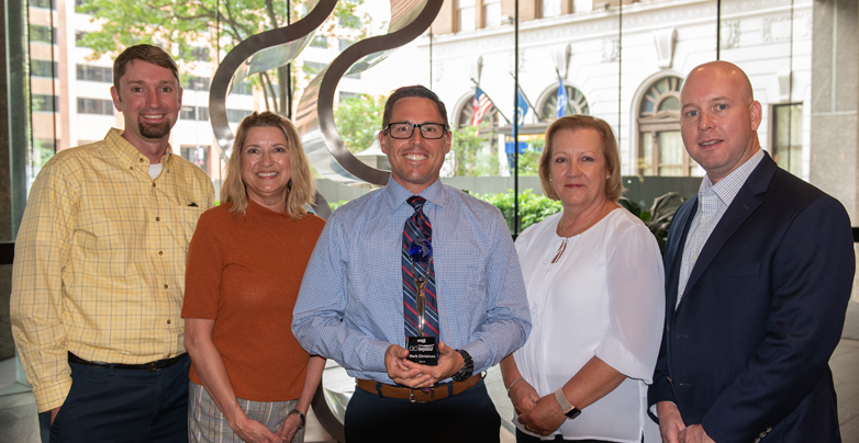 2019 Go Beyond agent award winner holding award with others