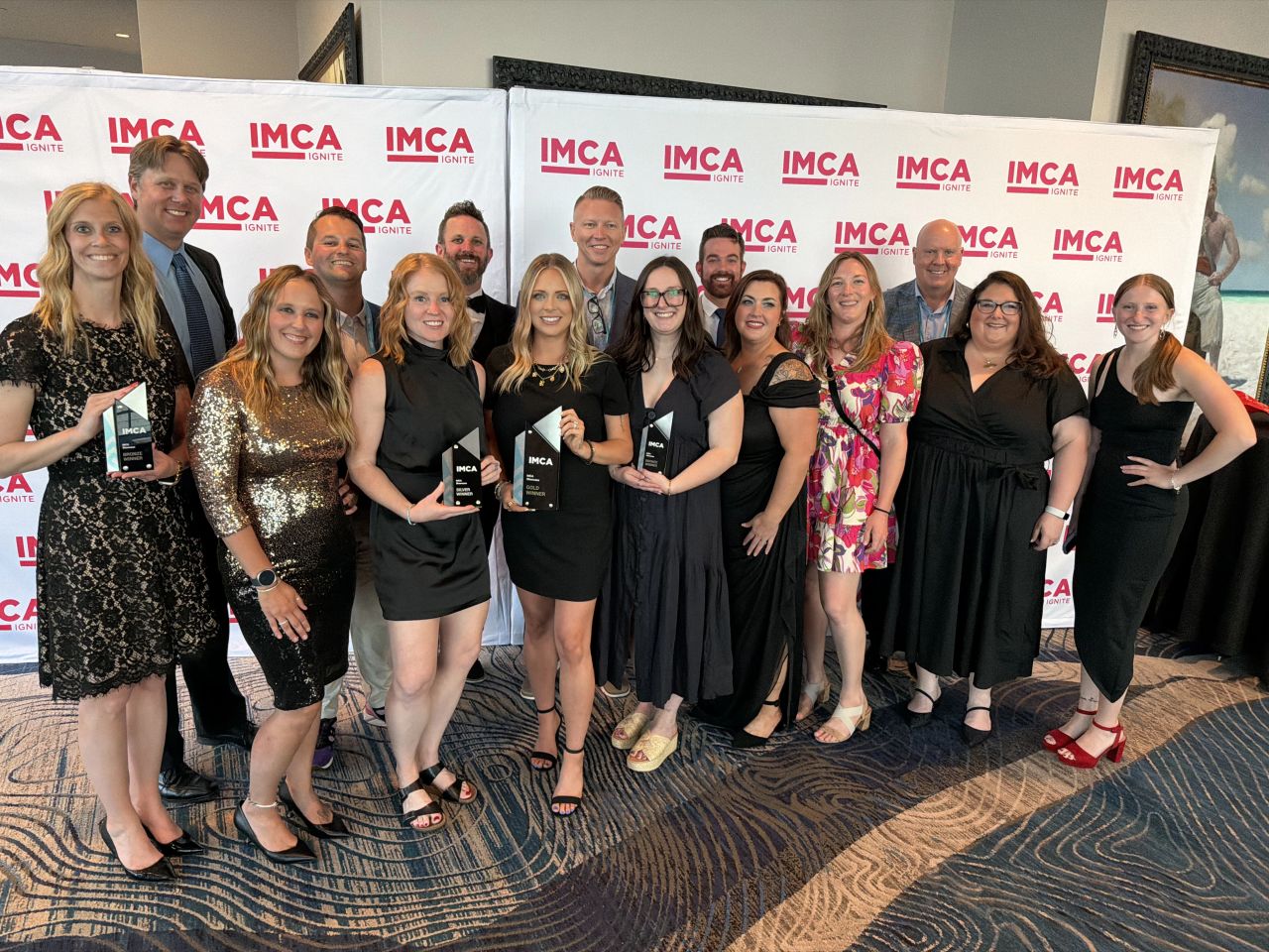 Group of people showcasing awards.