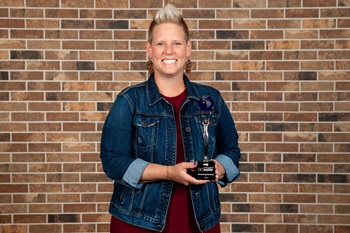IMG_9206 Woman smiling at camera with award.