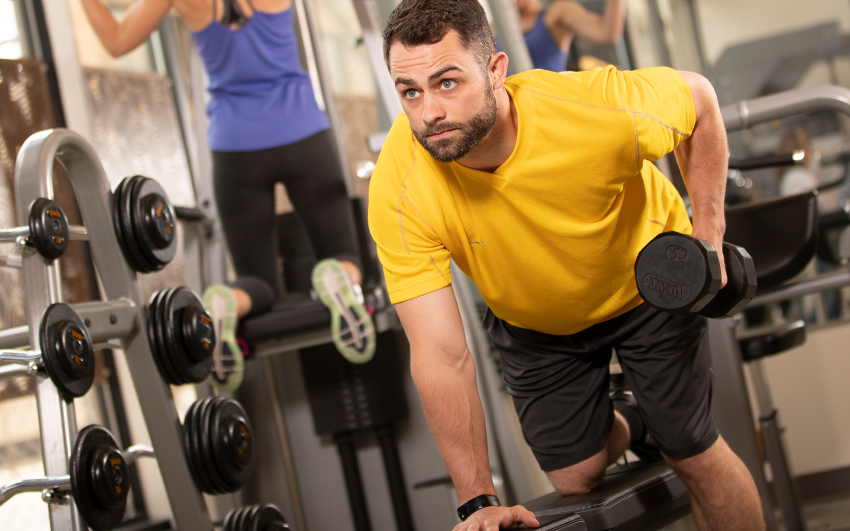 Careers-EmployeeBenefits-HealthHappiness Man in wellness center on gym equipment
