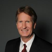 Professional man on gray background wearing a black jacket and tie