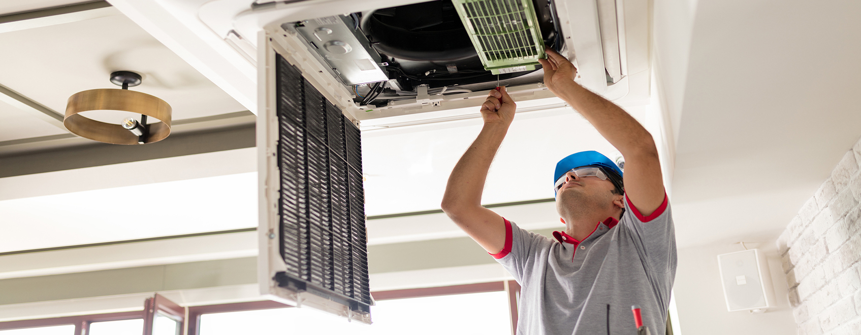 Contractor performing maintenance on an heating unit. 