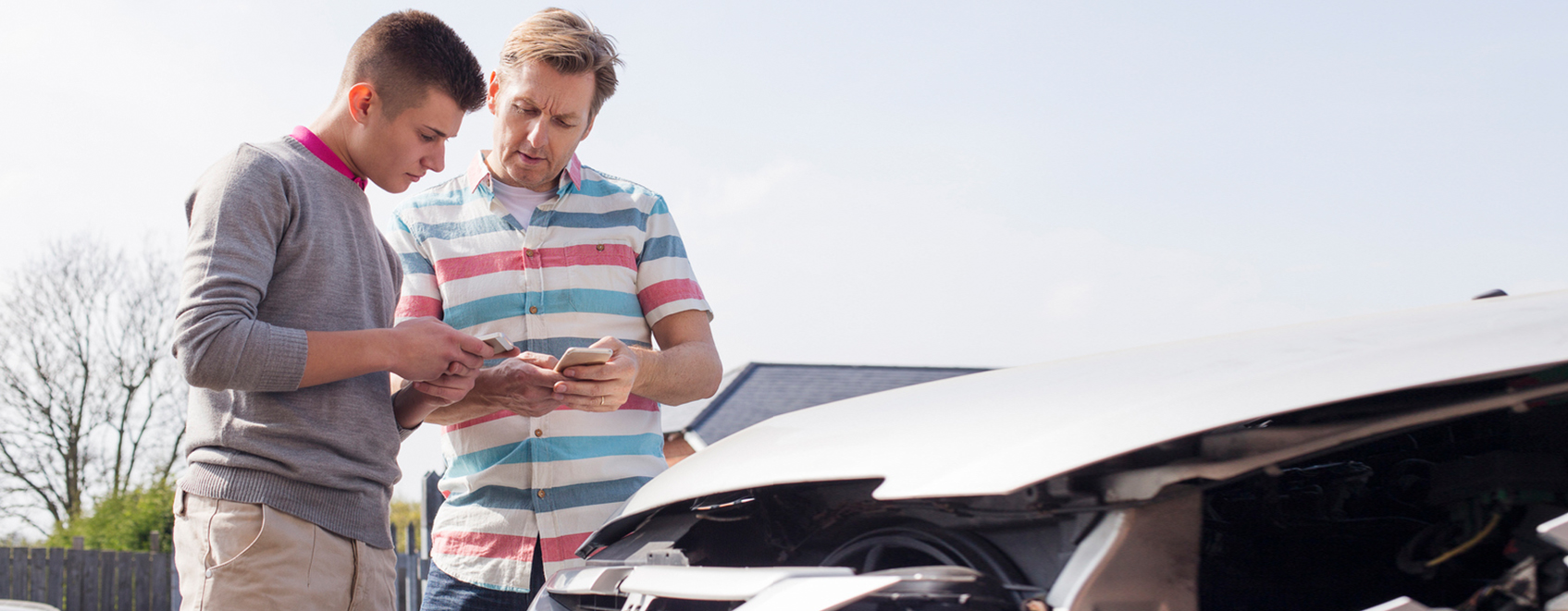 People discussing a car crash while looking at their phone.