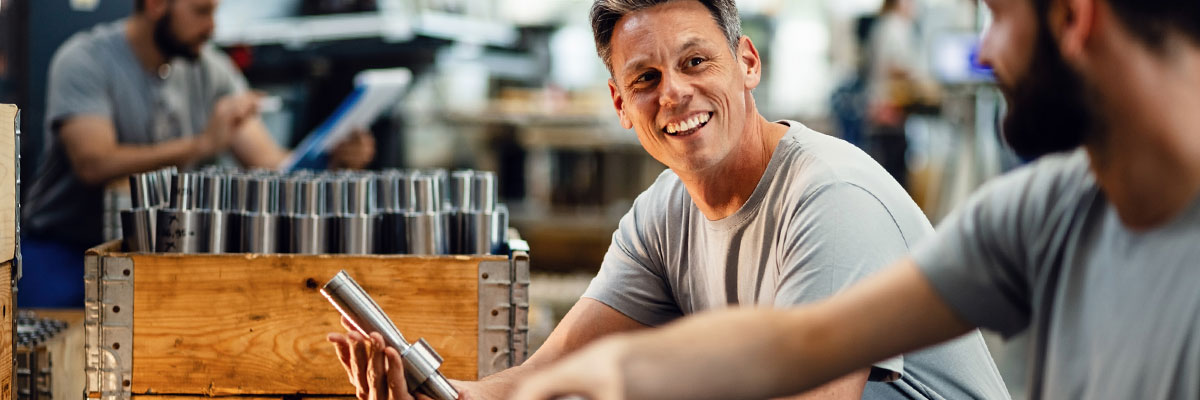 People talking at a workbench.