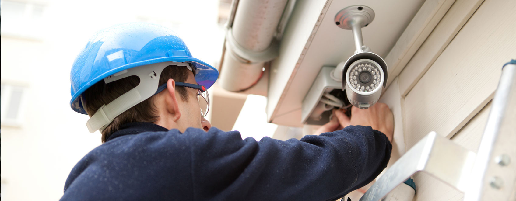 Technician installing security camera