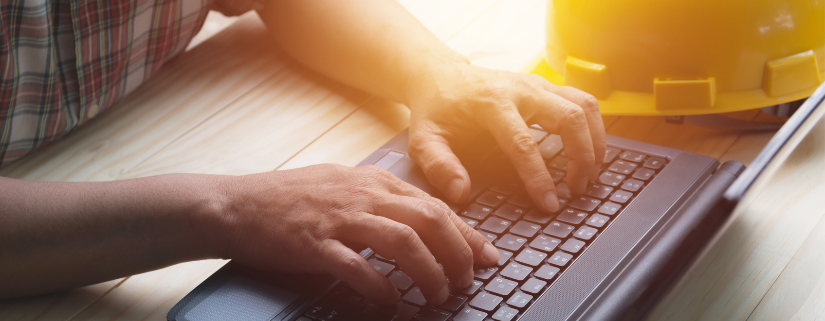 closeup of hands on laptop keyboard