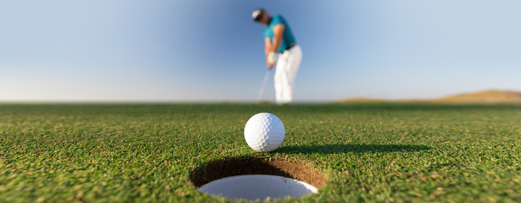 Golfer putting on a green. 