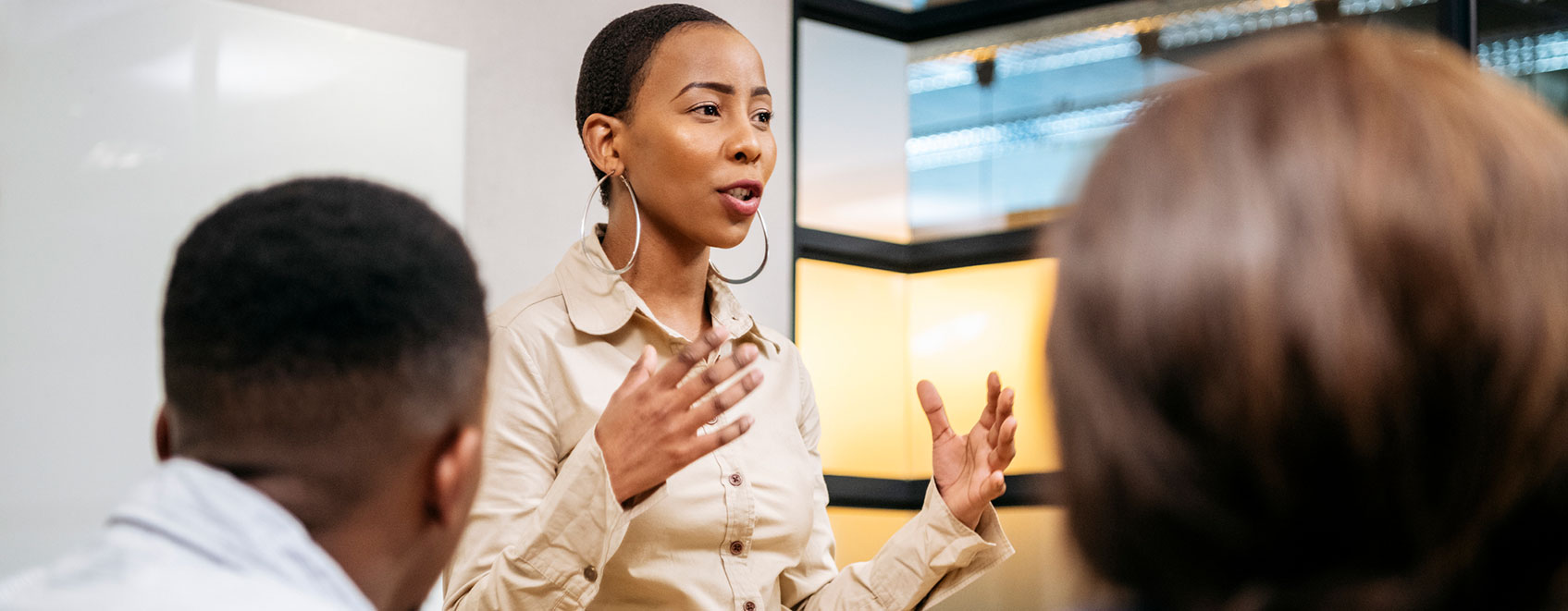 Female insurance agency leader speaking to a group of employees.