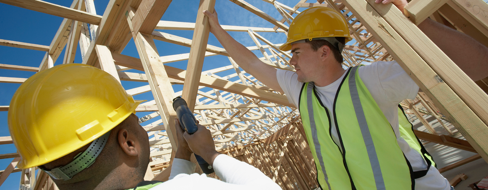 Construction workers setting up framing for new building.