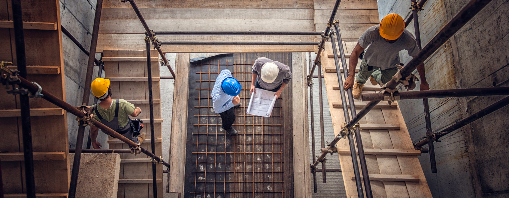 overhead view of construction professionals, talking together on a construction site