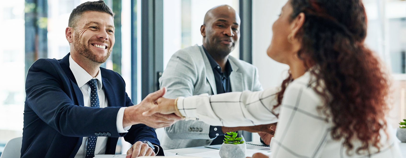 two people shaking hands in workplace