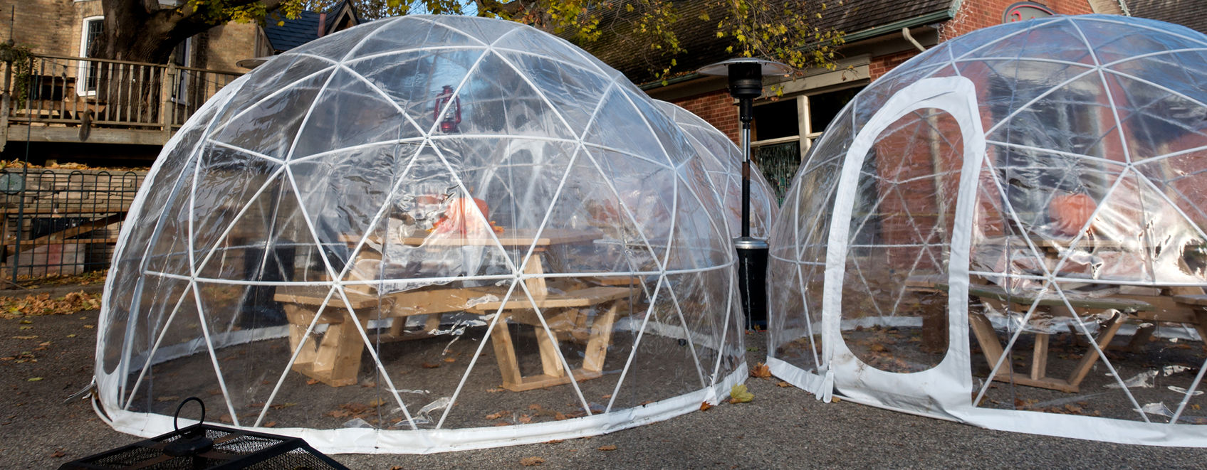 Outdoor dining tables, with clear bubble tents over them