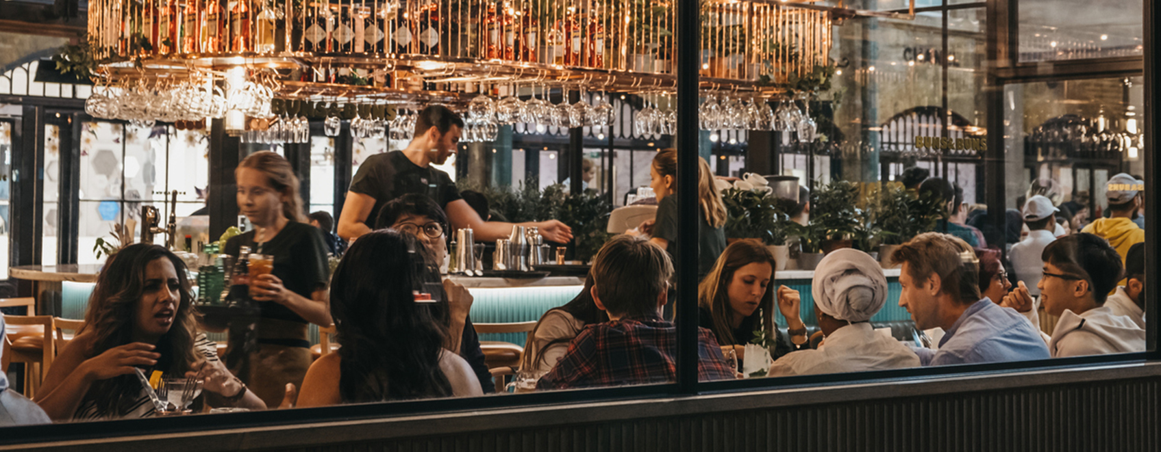 Diners sit in a crowded restaurant, illustrating the concept of restaurant insurance