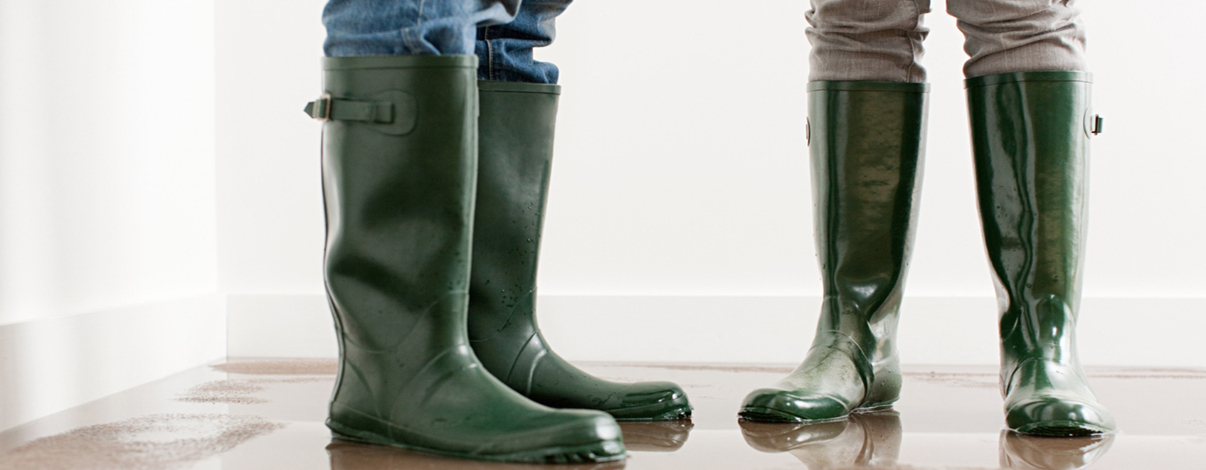 Business owners wearing boots in room with water backup