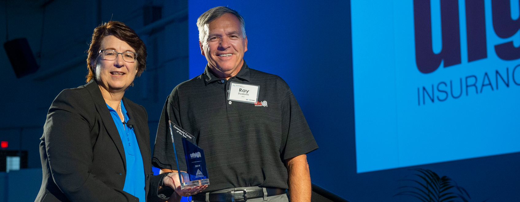 Ray Dudonis accepting an award on behalf of UFG Insurance in the East Coast office